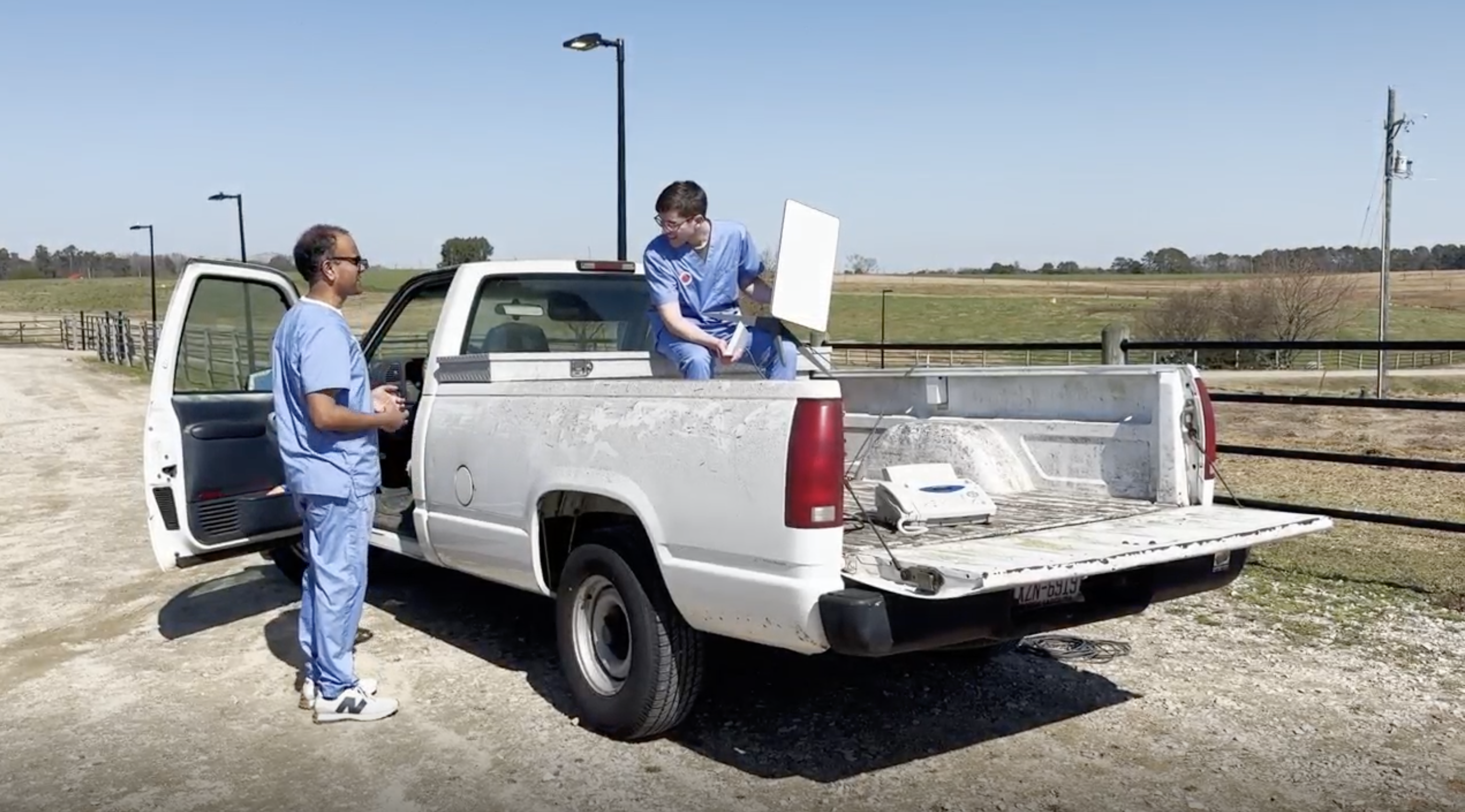 Neal and Gavry talking in front of mobile clinic truck